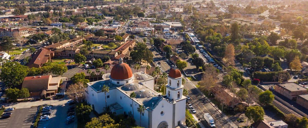 Daytime aerial view of the Spanish Colonial era mission and surrounding city of downtown San Juan Capistrano, California, USA.