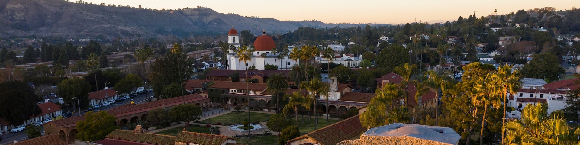 Sunset aerial view of the Spanish Colonial era mission and surrounding city of downtown San Juan Capistrano, California, USA.