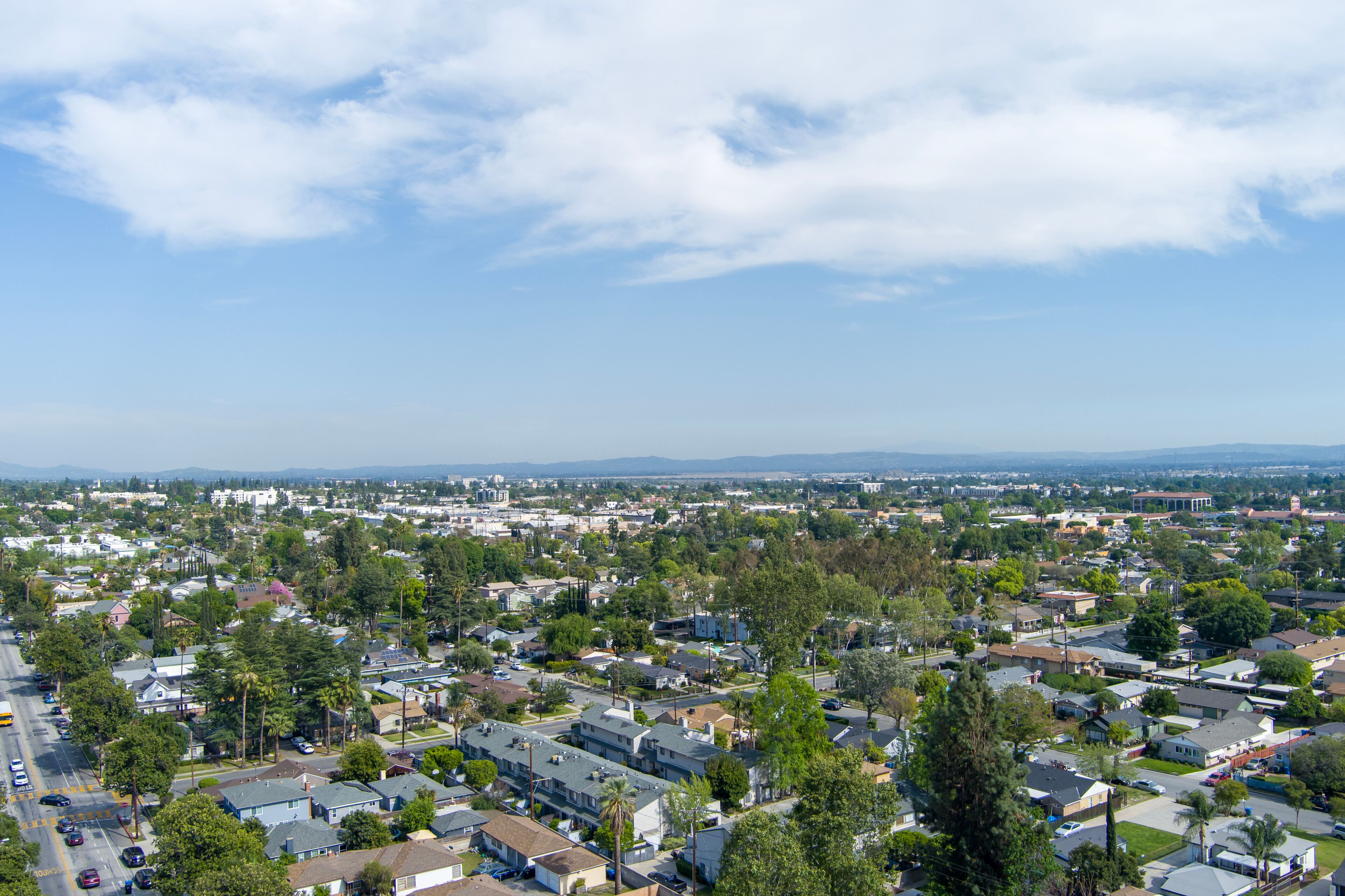 aerial shot of homes, lush green trees and and cars on the street in Monrovia California USA