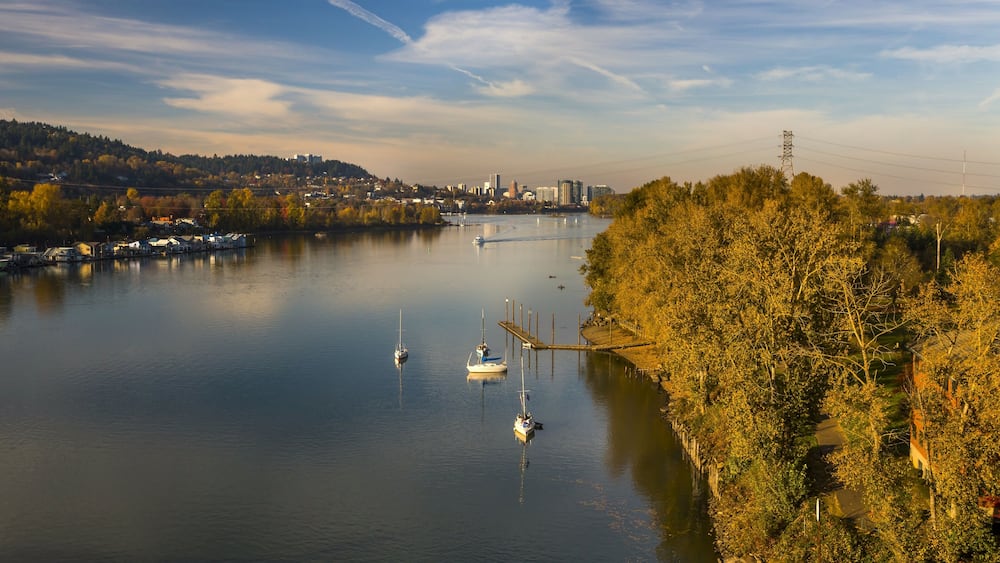 Recreation activity on the Willamette River in Milwaukie, Oregon. Portland cityscape on the background