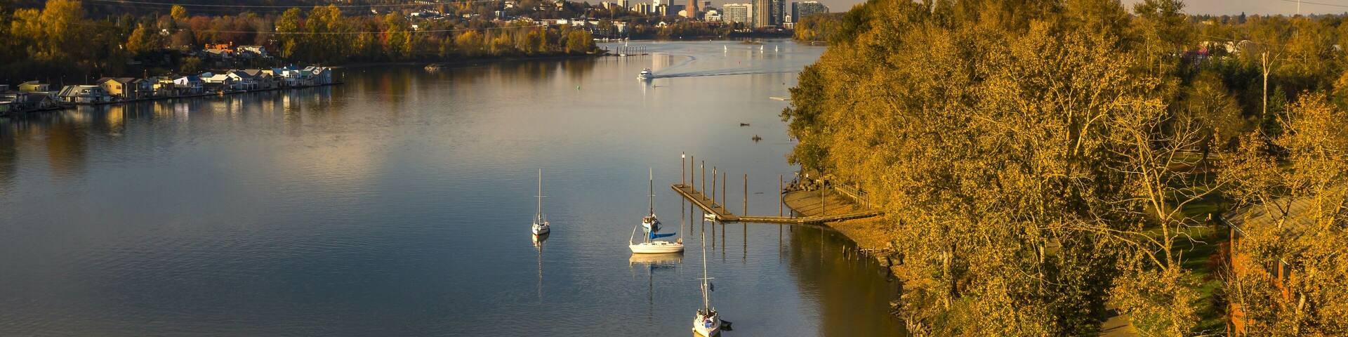 Recreation activity on the Willamette River in Milwaukie, Oregon. Portland cityscape on the background