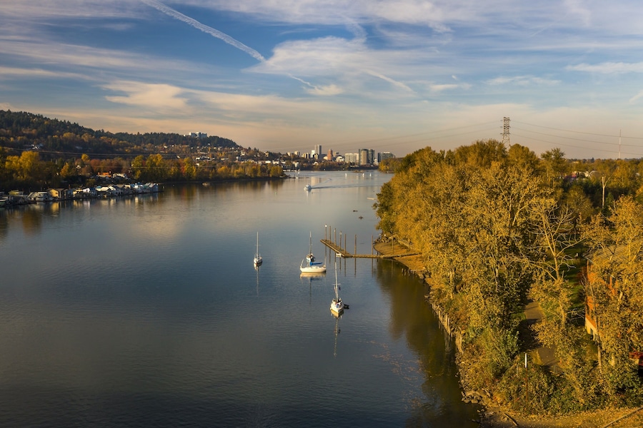 Recreation activity on the Willamette River in Milwaukie, Oregon. Portland cityscape on the background