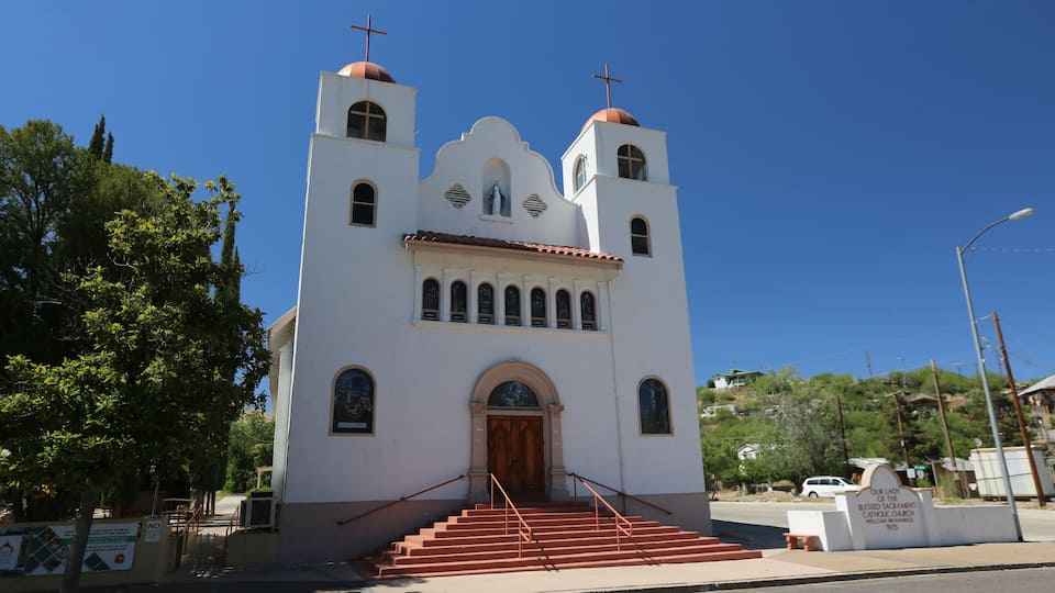 A white church with two towers and a wooden door.
