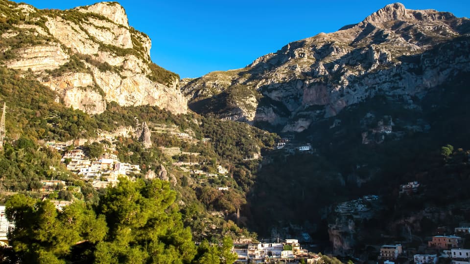 Panoramic view from coastal town Positano on mountain peaks of Monte San Michele, Molare, Canino, Caldare in Lattari Mountains, Apennines, Amalfi Coast, Italy, Europe. Parts of upper Positano village