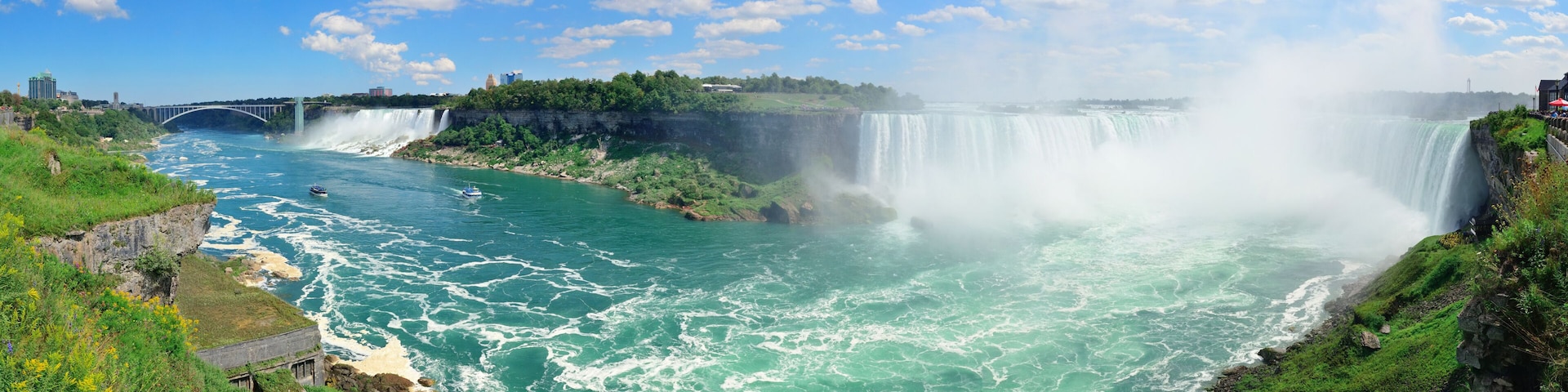 A large waterfall, a river, and a bridge.