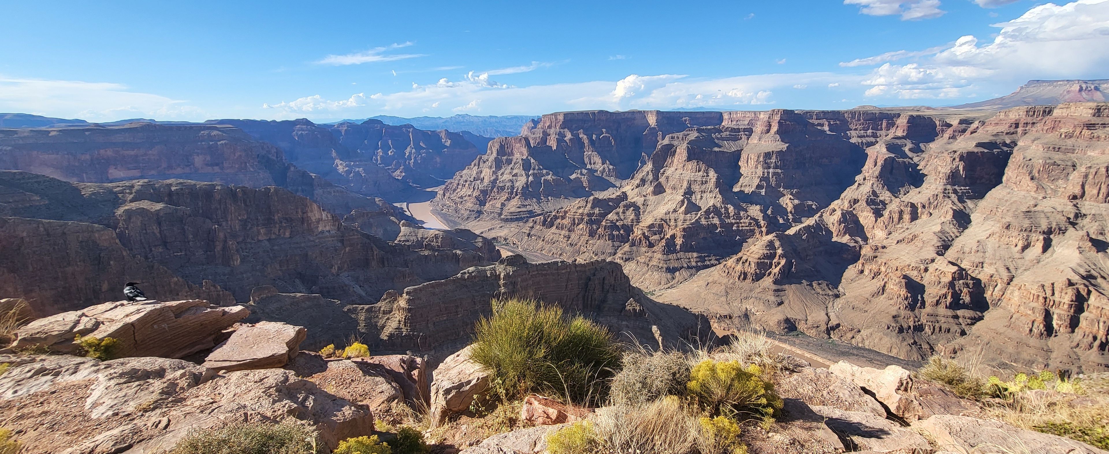 A canyon with a road cutting through it.