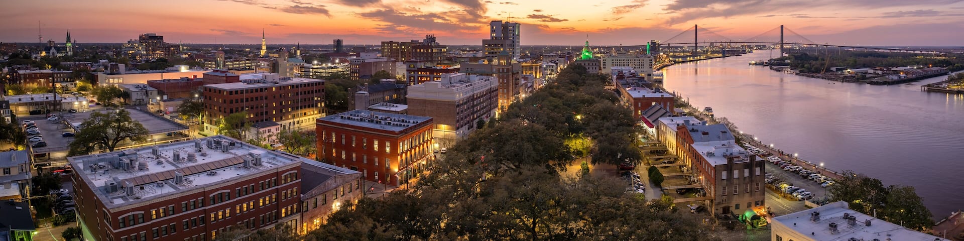 Savannah, Georgia. Old historic River Street architecture. View from above of illuminated streets at night. USA tourist attraction