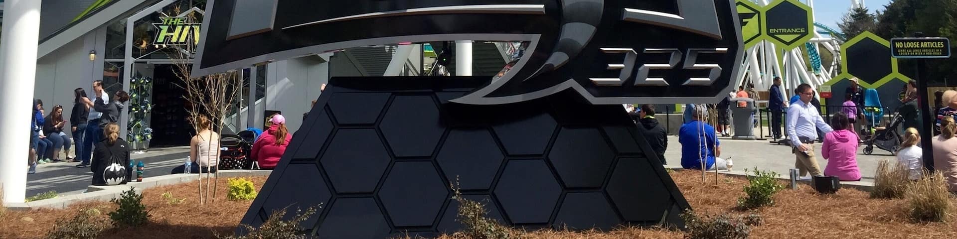 A large sign for 'Fury 325' with a roller coaster in the background.