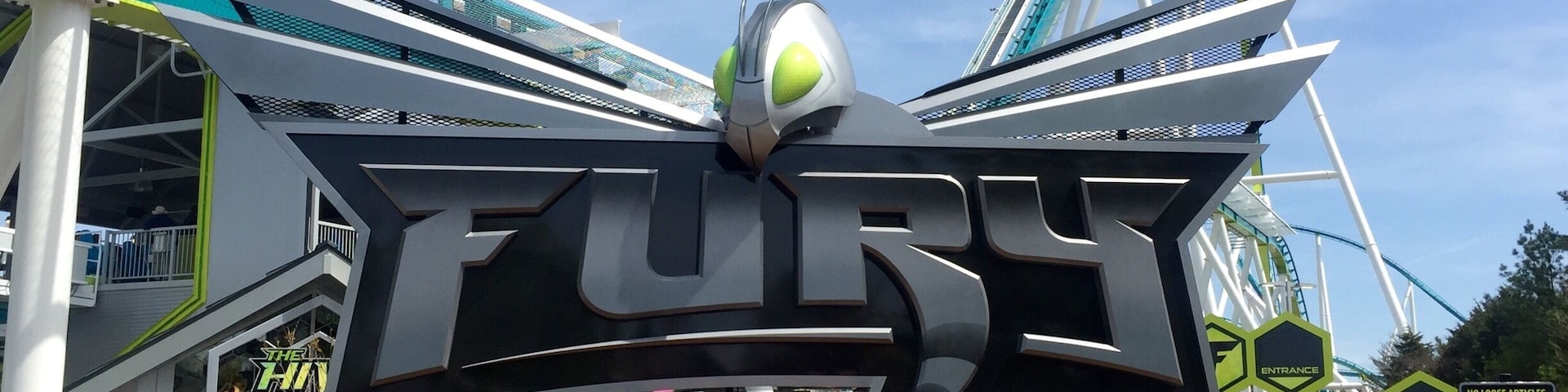 A large sign for 'Fury 325' with a roller coaster in the background.