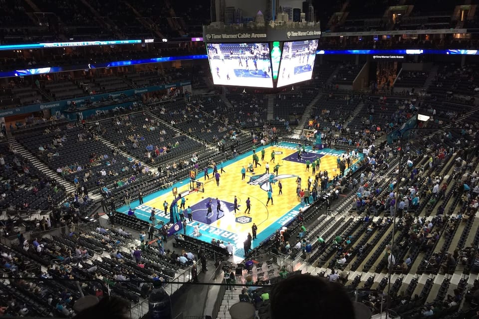 A basketball game at the Time Warner Cable Arena with spectators in the stands.