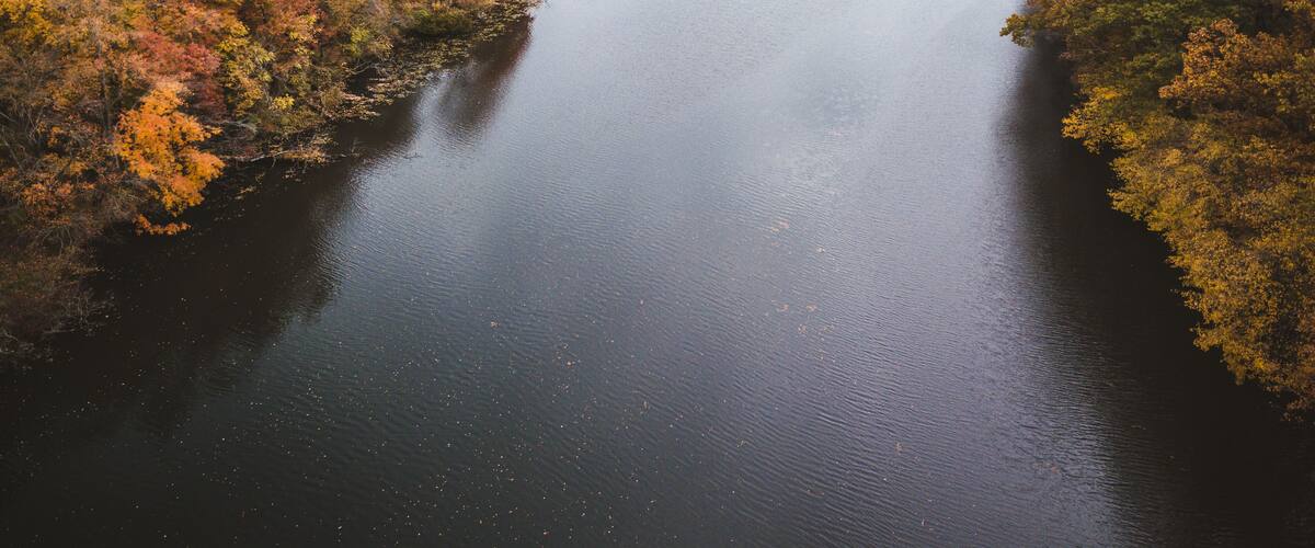 A river surrounded by autumn foliage.