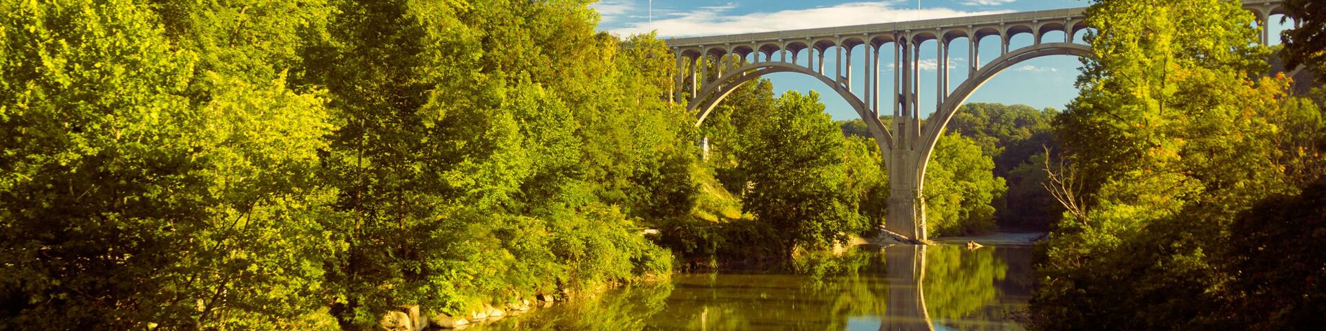 Arch bridge spanning a river in Cuyahoga Valley National Park