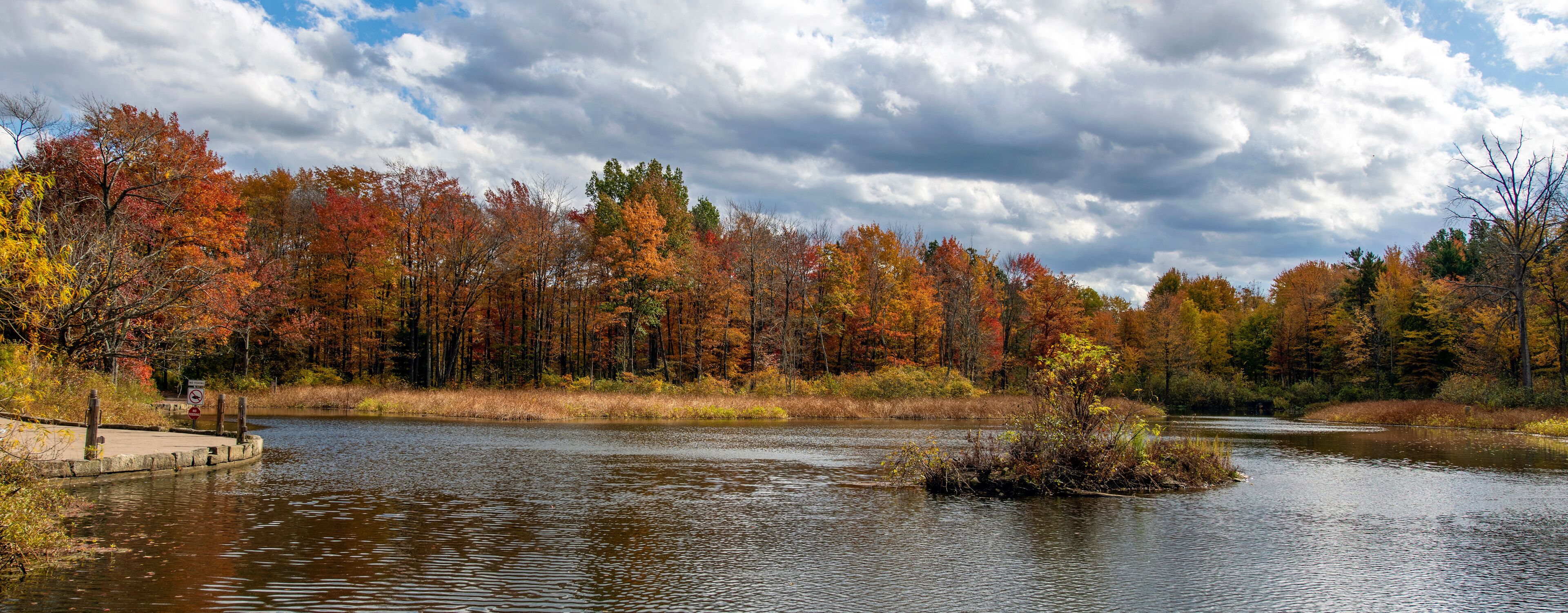 A river surrounded by autumn-colored trees.