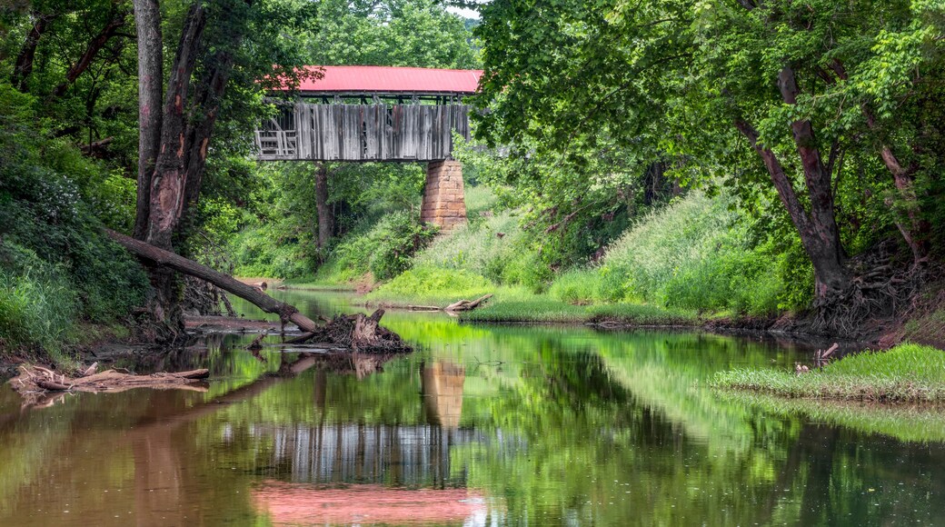 Historic Knowlton Covered Bridge is seen reflected in the waters of the Little Muskingom River in rural Monroe County, Ohio. This old bridge collapsed in the summer of 2019.