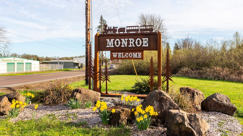 Monroe Welcome sign on the highway