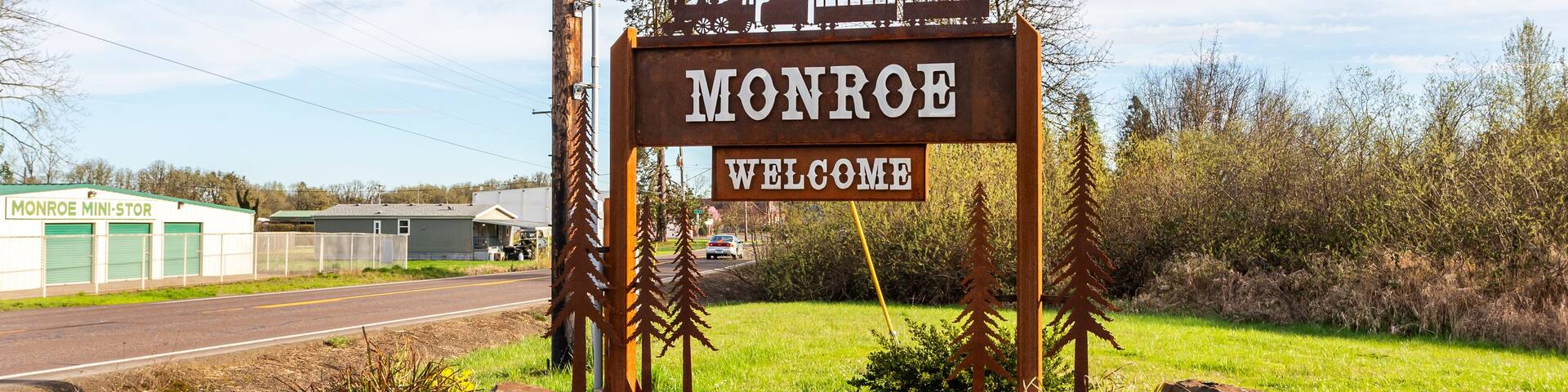 Monroe Welcome sign on the highway