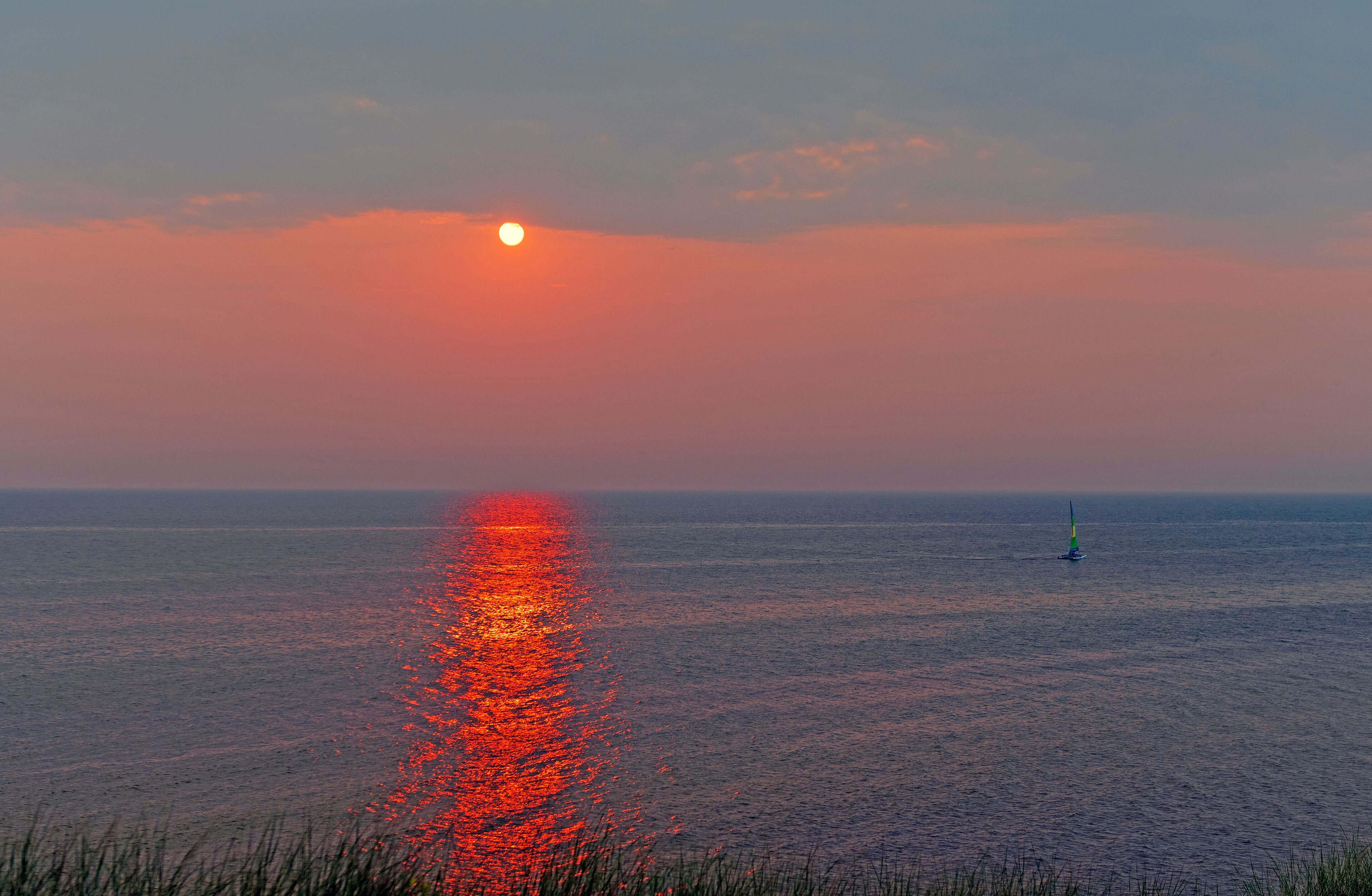 Sailboat and a Cloudy Sunset