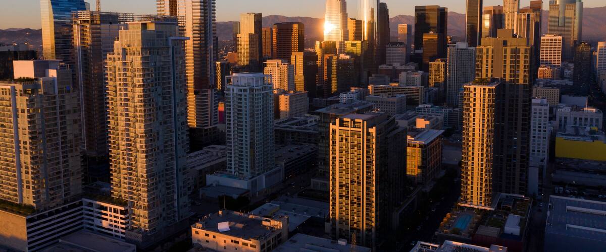 Sunset aerial view of the skyscrapers of the South Park neighborhood in Downtown Los Angeles, California, USA.