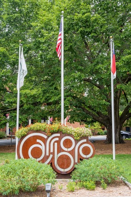 Photo of the Carrboro city sign in front of the Carrboro Town Hall in Carrboro, NC