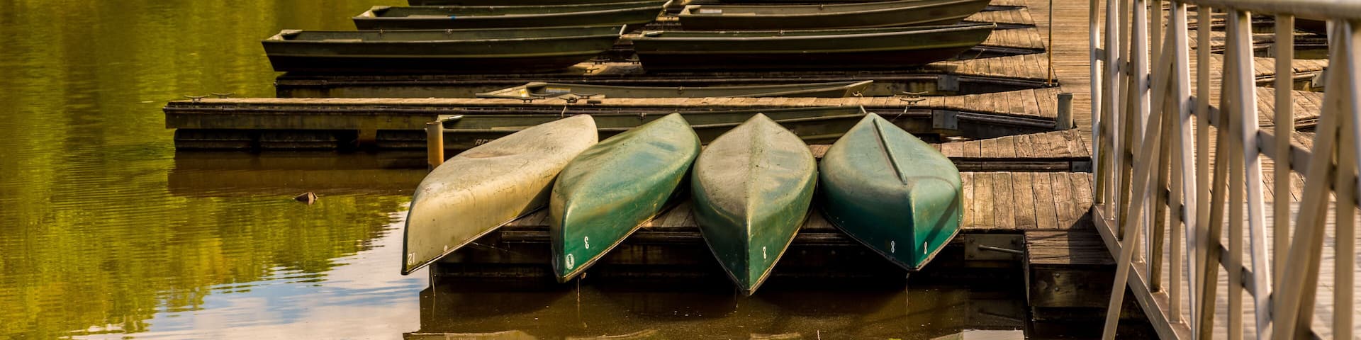 Canoes upside down on a dock on a lake