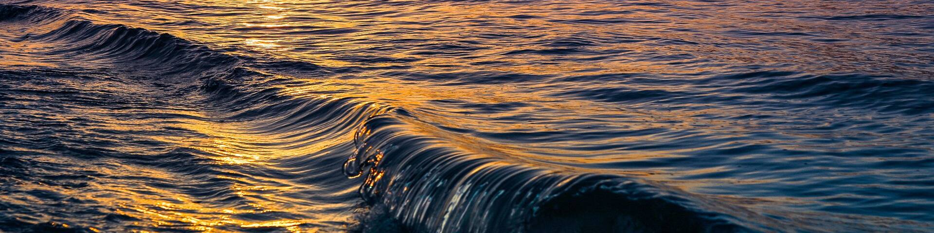 Wave crushing st sunset. Sunken Meadow beach, Long Island New York. Summer travel concept