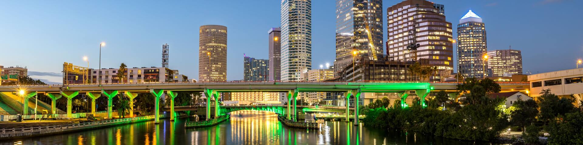 Tampa skyline with skyscrapers real estate panorama bridge over Hillsborough River at night in downtown Tampa, United States