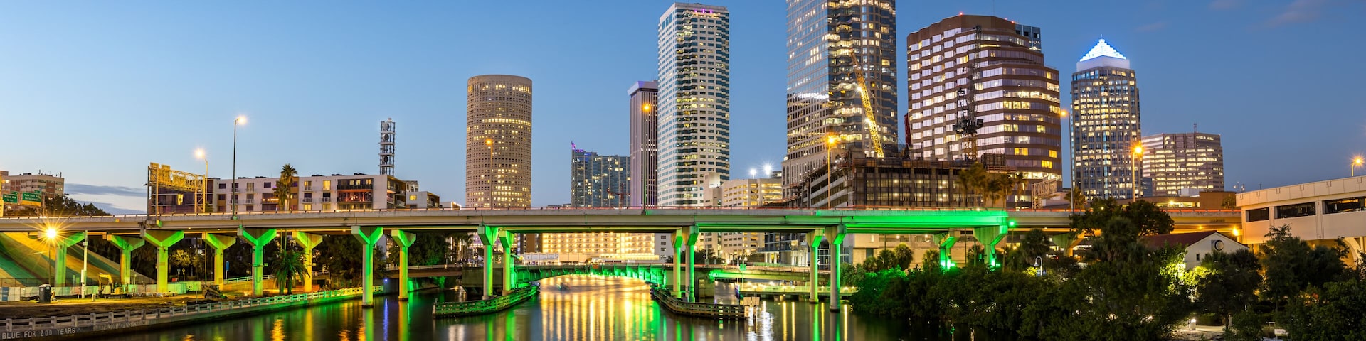 Tampa skyline with skyscrapers real estate panorama bridge over Hillsborough River at night in downtown Tampa, United States