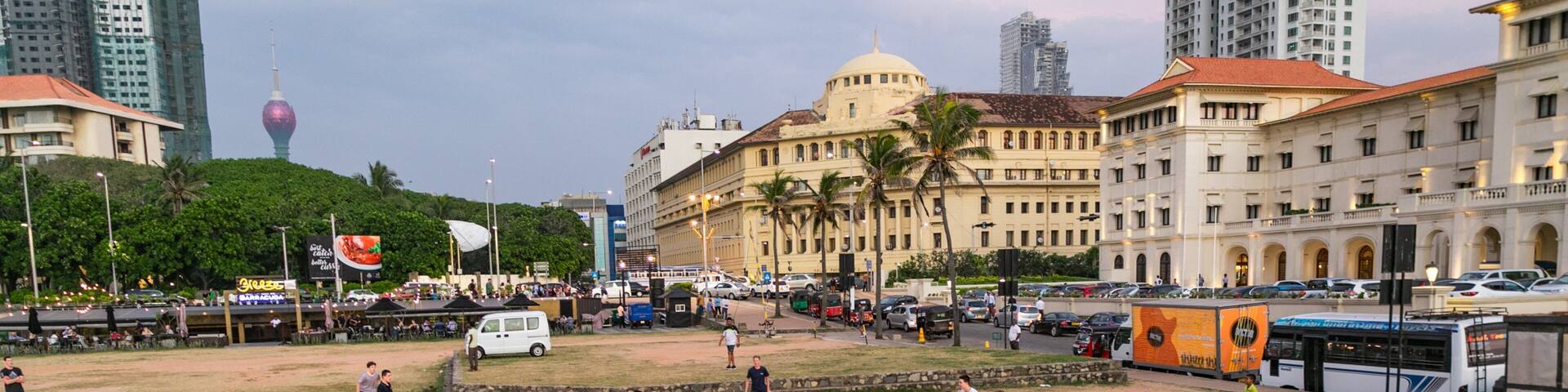 Colombo which includes a coastal town and a sporting event as well as a large group of people