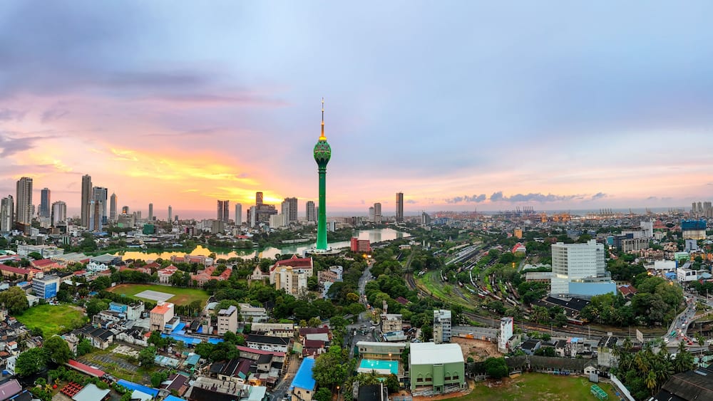 A cityscape with a prominent tower, dense urban buildings, and a river.