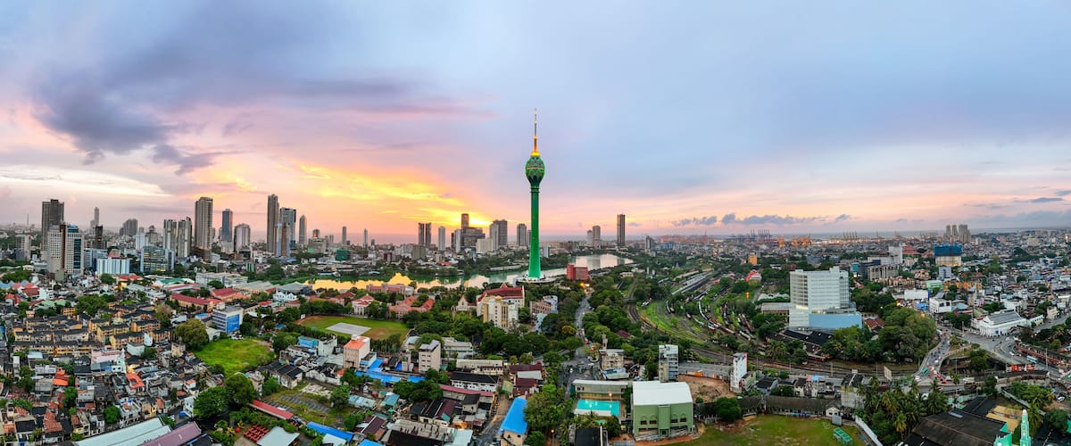 A cityscape with a prominent tower, dense urban buildings, and a river.