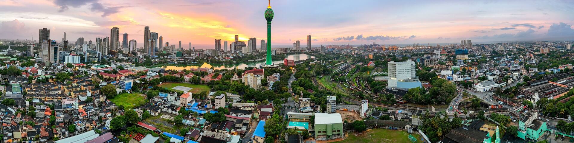 A cityscape with a prominent tower, dense urban buildings, and a river.
