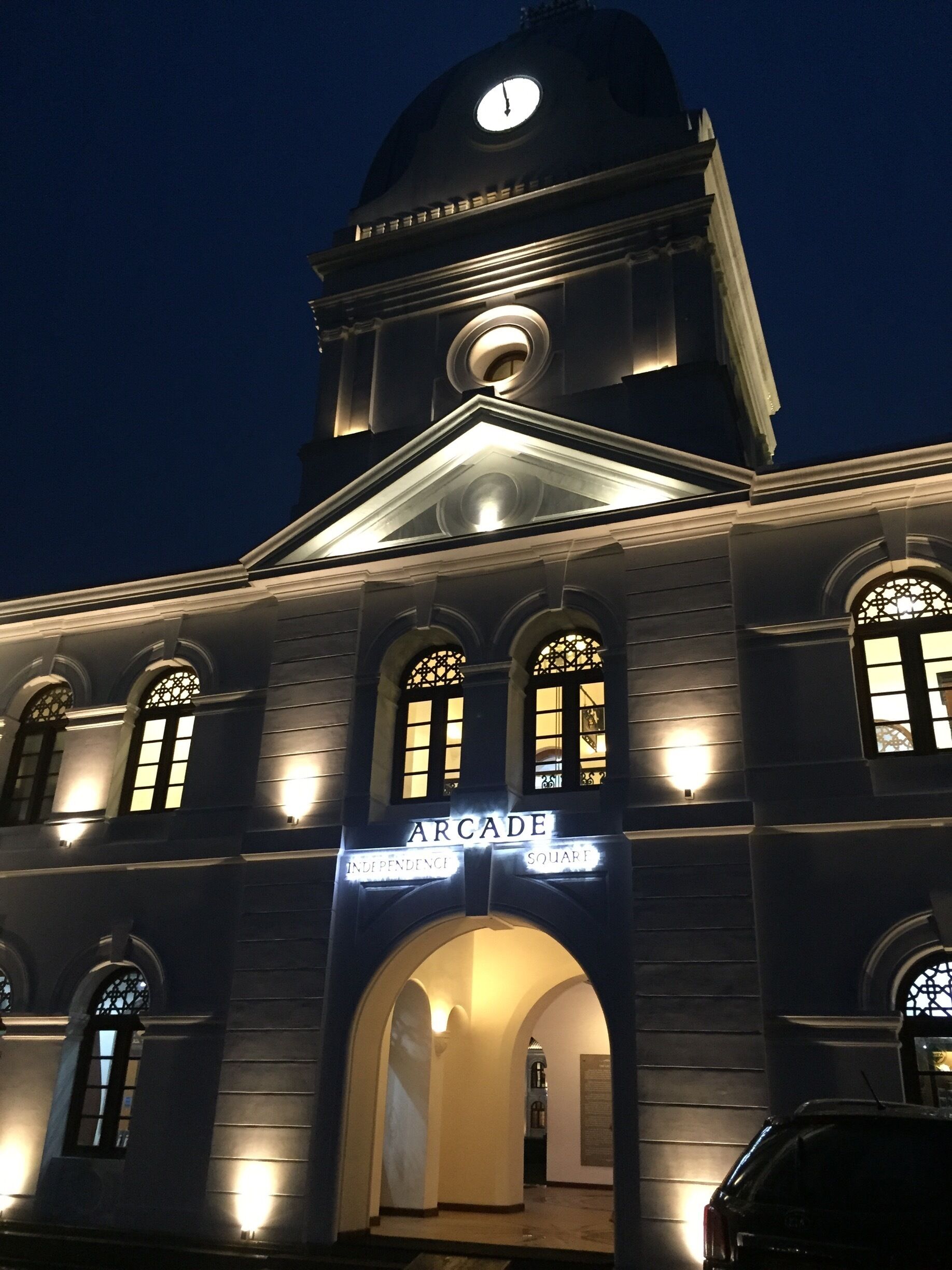 The main entrance to the "independence Arcade" overlooking Independence Square at dusk. This clock tower building was restored to its former glory early this year. Now housing some of the up market retail stores.
