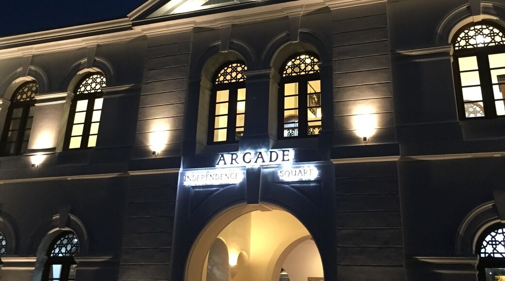 The main entrance to the "independence Arcade" overlooking Independence Square at dusk. This clock tower building was restored to its former glory early this year. Now housing some of the up market retail stores.