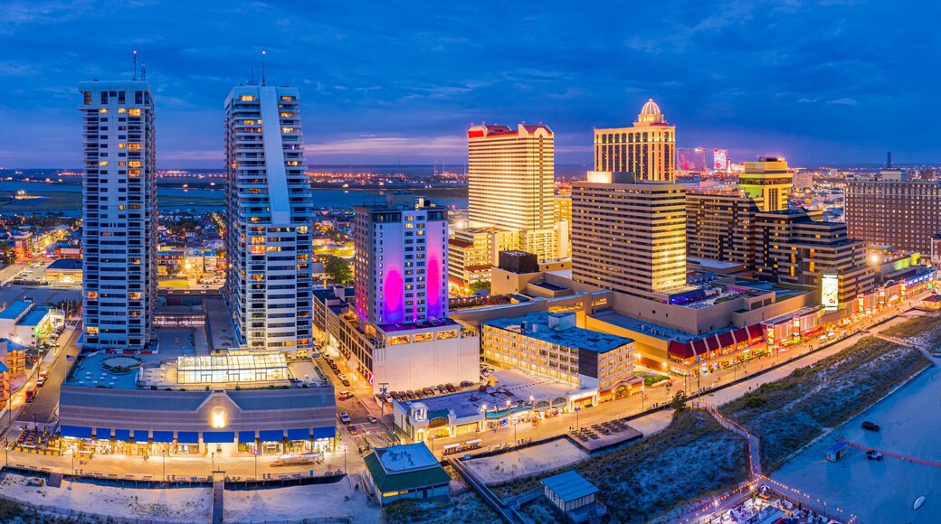 Aerial panorama of Atlantic city along the boardwalk at dusk. In the 1980s, Atlantic City achieved nationwide attention as a gambling resort and currently has nine large casinos.