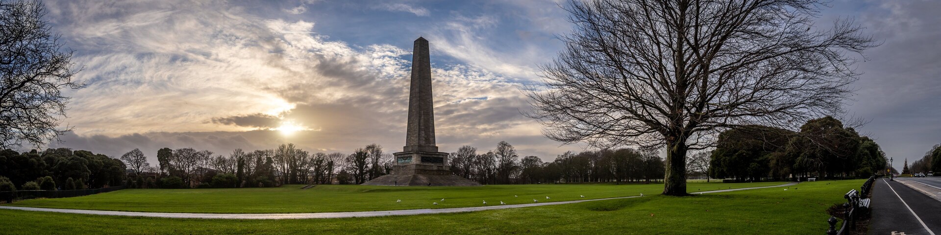 DUBLIN, IRELAND, DECEMBER 21, 2018: Beautiful panoramic view of Phoenix Park and Wellington Monument obelisk, also known as the Wellington Testimonial, during sunset on a colorful partly cloudy day.