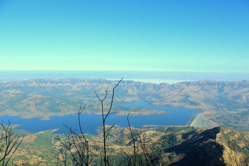 A mountainous landscape with a large lake and a dam.