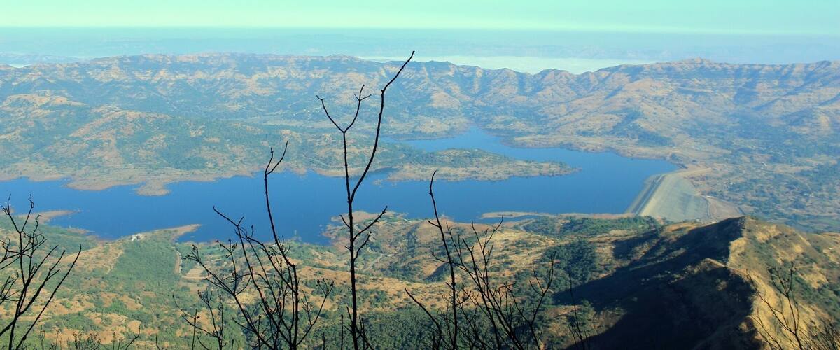 A mountainous landscape with a large lake and a dam.