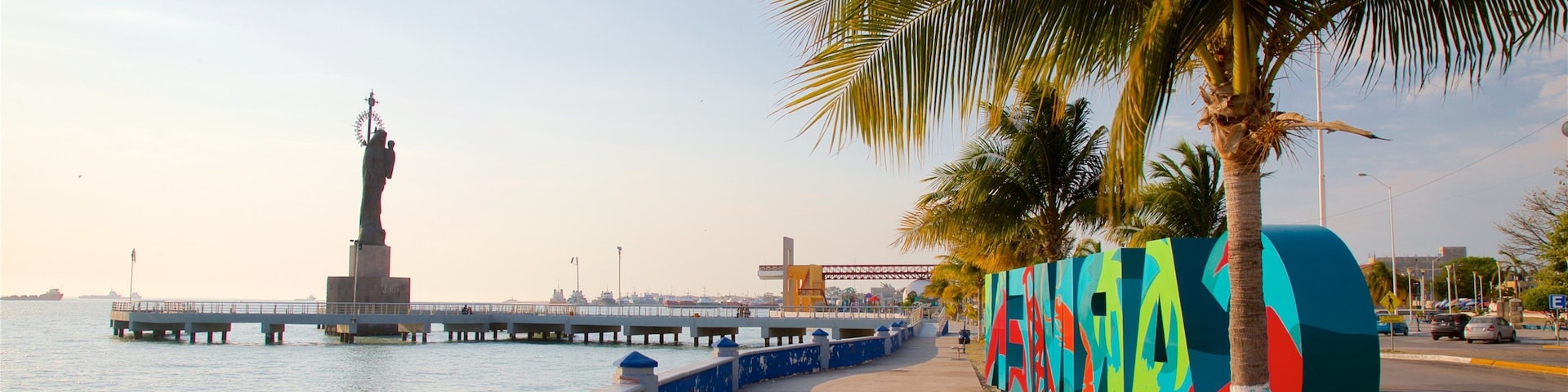 Ciudad del Carmen featuring signage, a statue or sculpture and tropical scenes