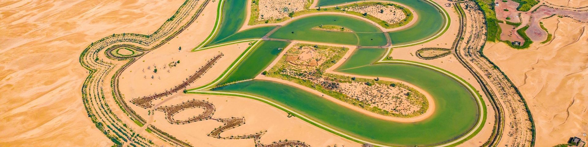Aerial top view of love lake and sand desert, Heart shaped lakes in Al Qudra in Dubai, United Arab Emirates or UAE. A new tourist destination for valentine day. Natural landscape background