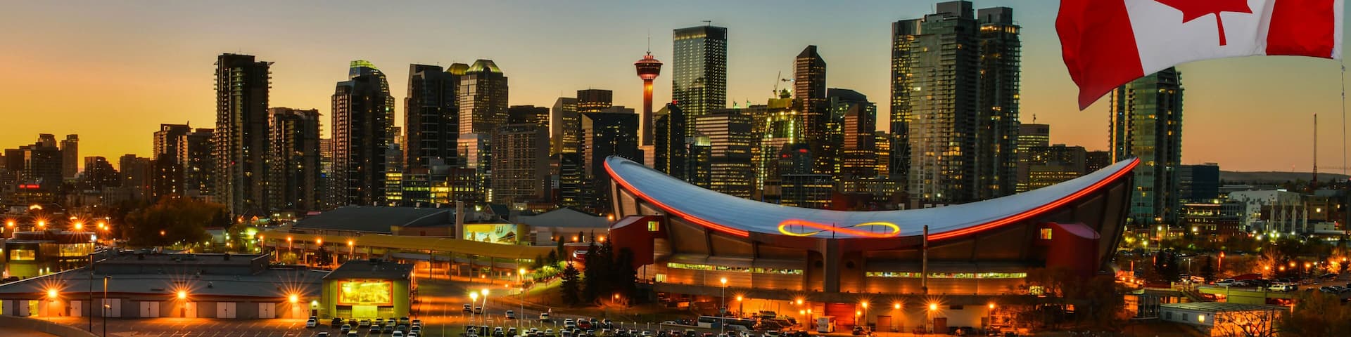 Canadian flag in front of view Calgary city skyline at twilight time, Alberta,Canada