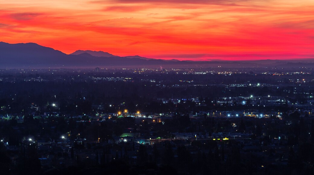 Colorful predawn view of San Fernando Valley neighborhoods and the San Gabriel Mountains in the city of Los Angeles, California.