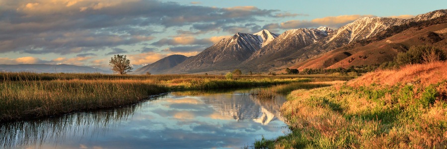 Carson Valley Sunrise in Genoa, Nevada with a reflection of a snow capped mountain called Job's Peak and a moody cloudy sky