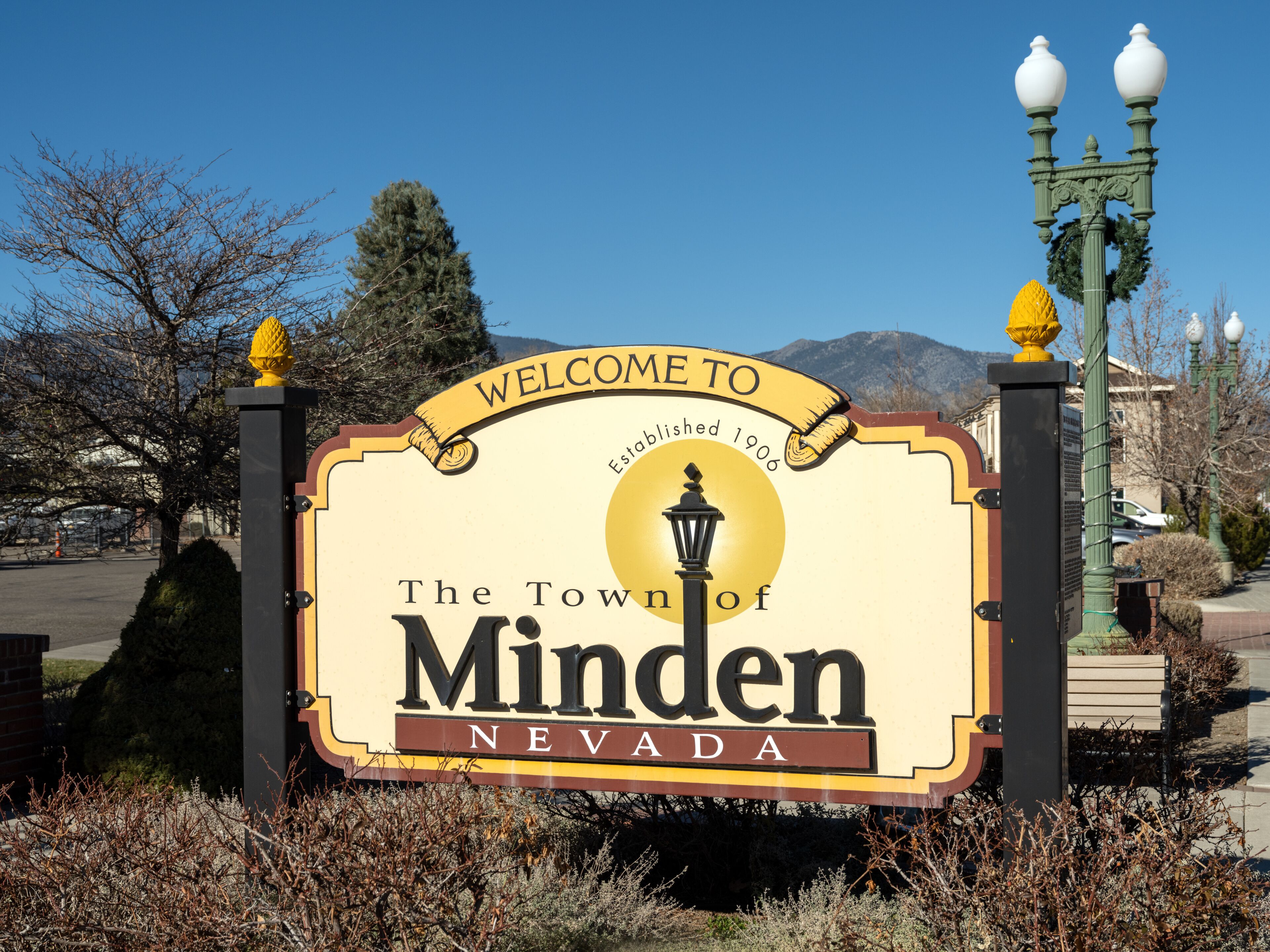 A welcome sign for The Town of Minden, Nevada, with a mountain backdrop.