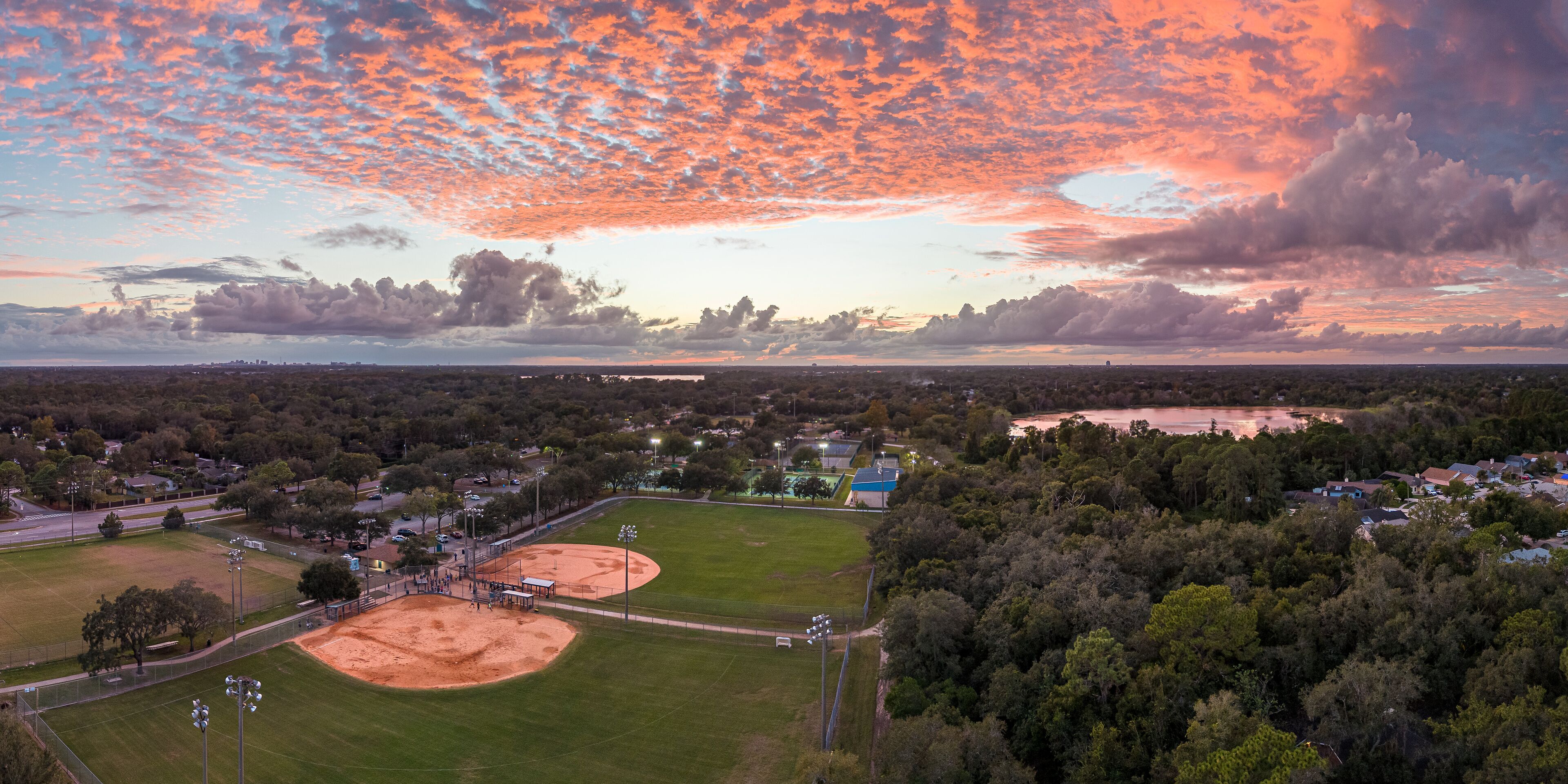 Natural sunset, aerial panoramic of Red Bug Lake Park, Casselberry, Florida. October 29, 2022.