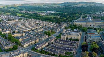 An aerial drone shot of Saltaire,the Victorian era Salt's Mill and associated residential district located by the River Aire and Leeds and Liverpool Canal is a designated UNESCO World Heritage Site an