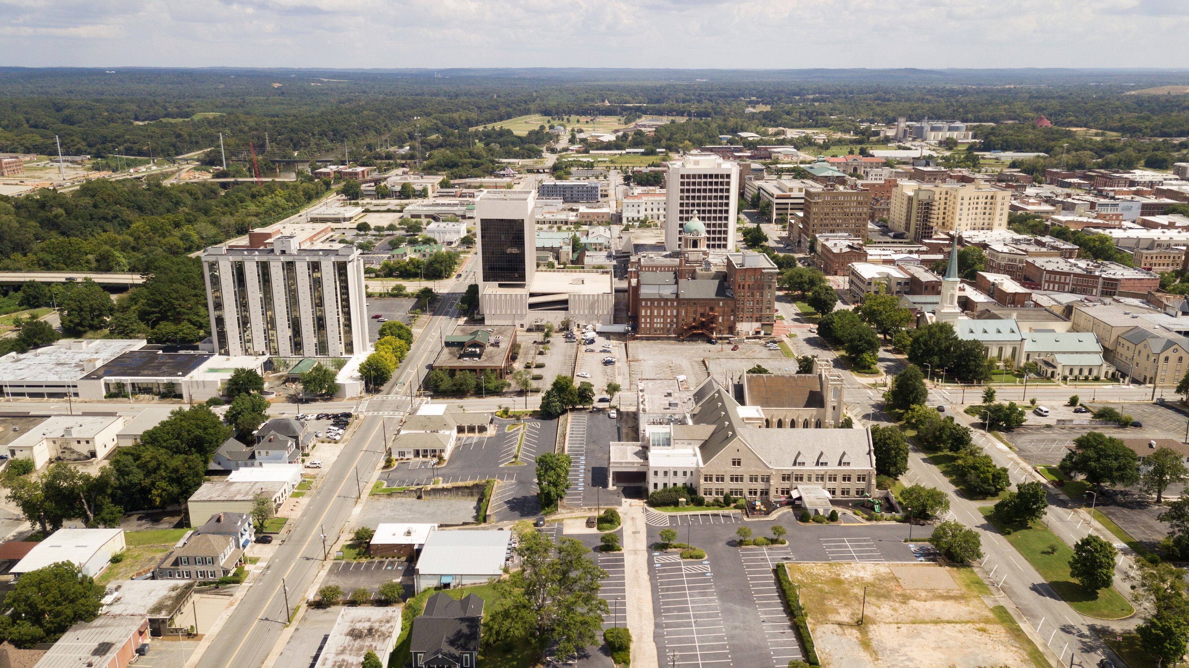 Blue skies with soft white clouds appear in the horizon over the landscape of downtown Macon Georgia