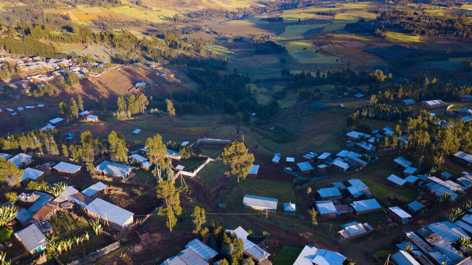 An aerial view of a rural area with scattered houses and fields.