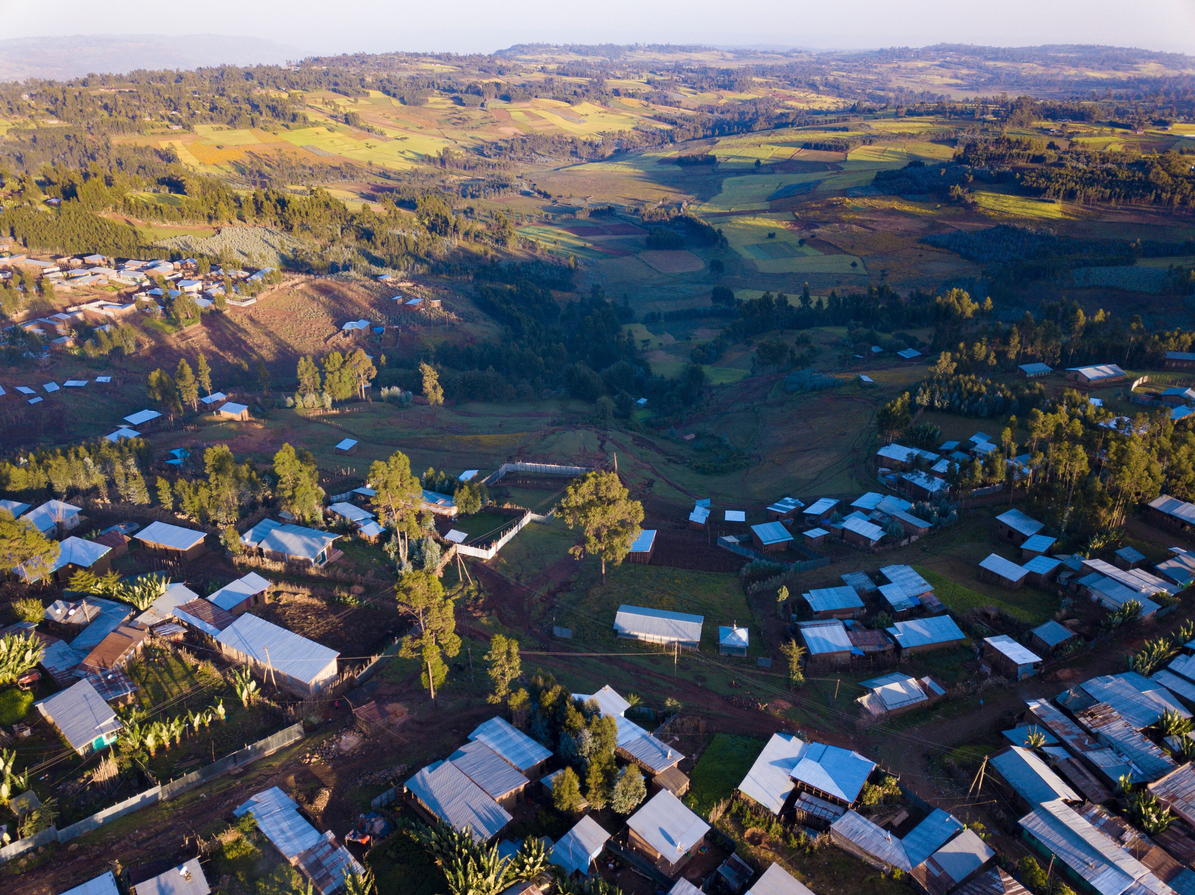 An aerial view of a rural area with scattered houses and fields.