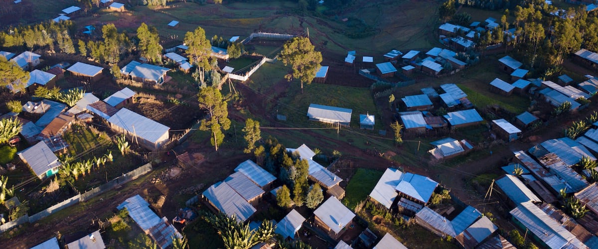 An aerial view of a rural area with scattered houses and fields.