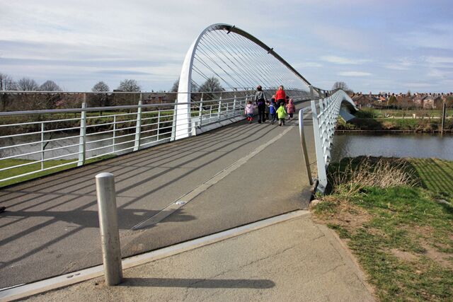 The Millennium bridge over the river Ouse This is a westward view including pedestrians.